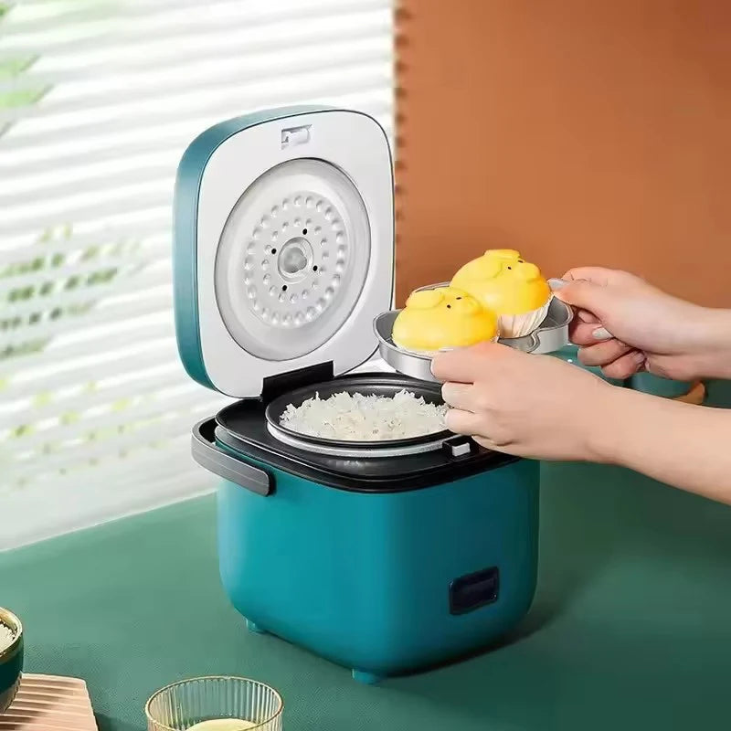 Mini electric rice cooker, teal body with open lid and inner steaming plate