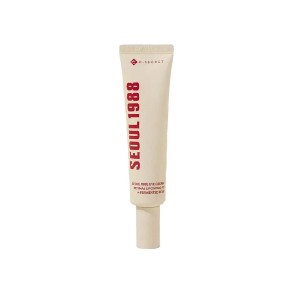 K-Secret eye cream tube, beige-cream tube with white cap and vertical red text