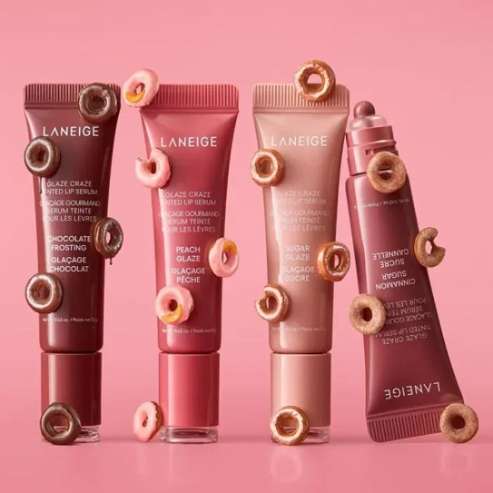 Laneige Glazey Lip Serum collection in assorted shades with donut decorations on a pink background.