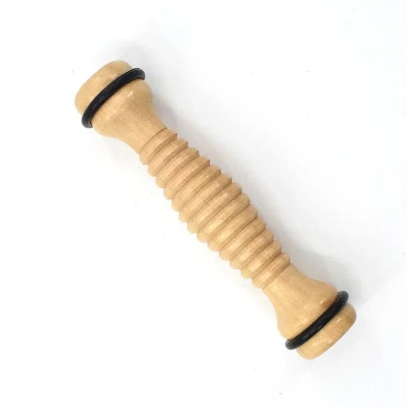 Ridged wooden foot massage roller with black rubber rings on ends for grip and pressure.
