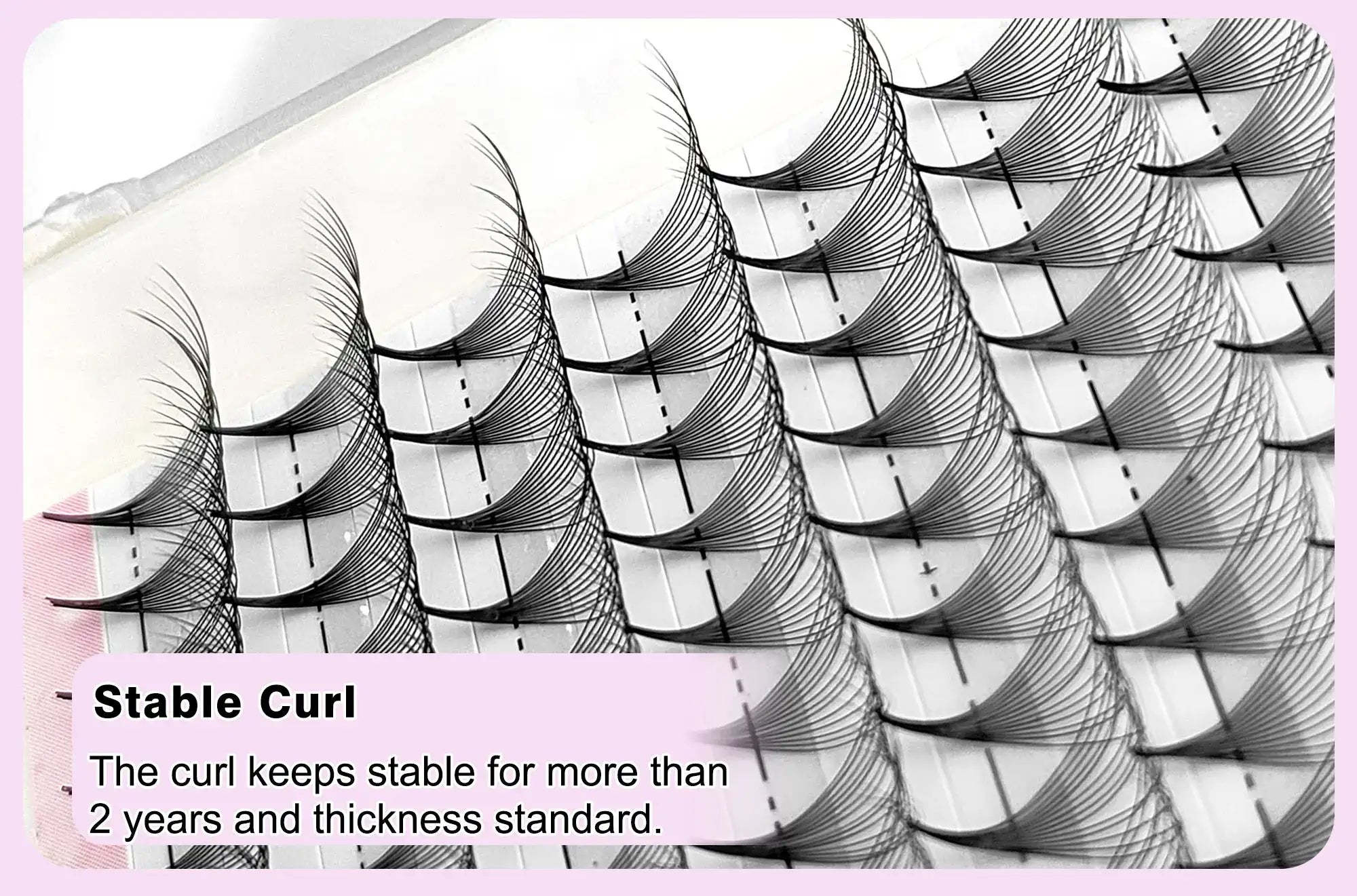Black synthetic volume eyelash extension fans arranged in rows on a sticky tray for professional application.