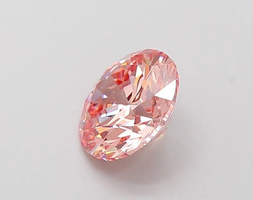 Oval-shaped pink gemstone with faceted surface