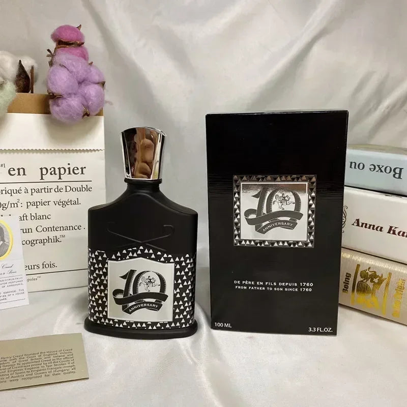 Creed 10th Anniversary EDP for unisex: black patterned glass bottle with metallic cap and original fragrance box.