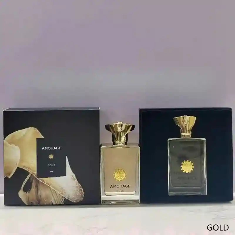 Amouage Gold Man perfume bottle and black gift box with gold crest emblem and decorative floral packaging.