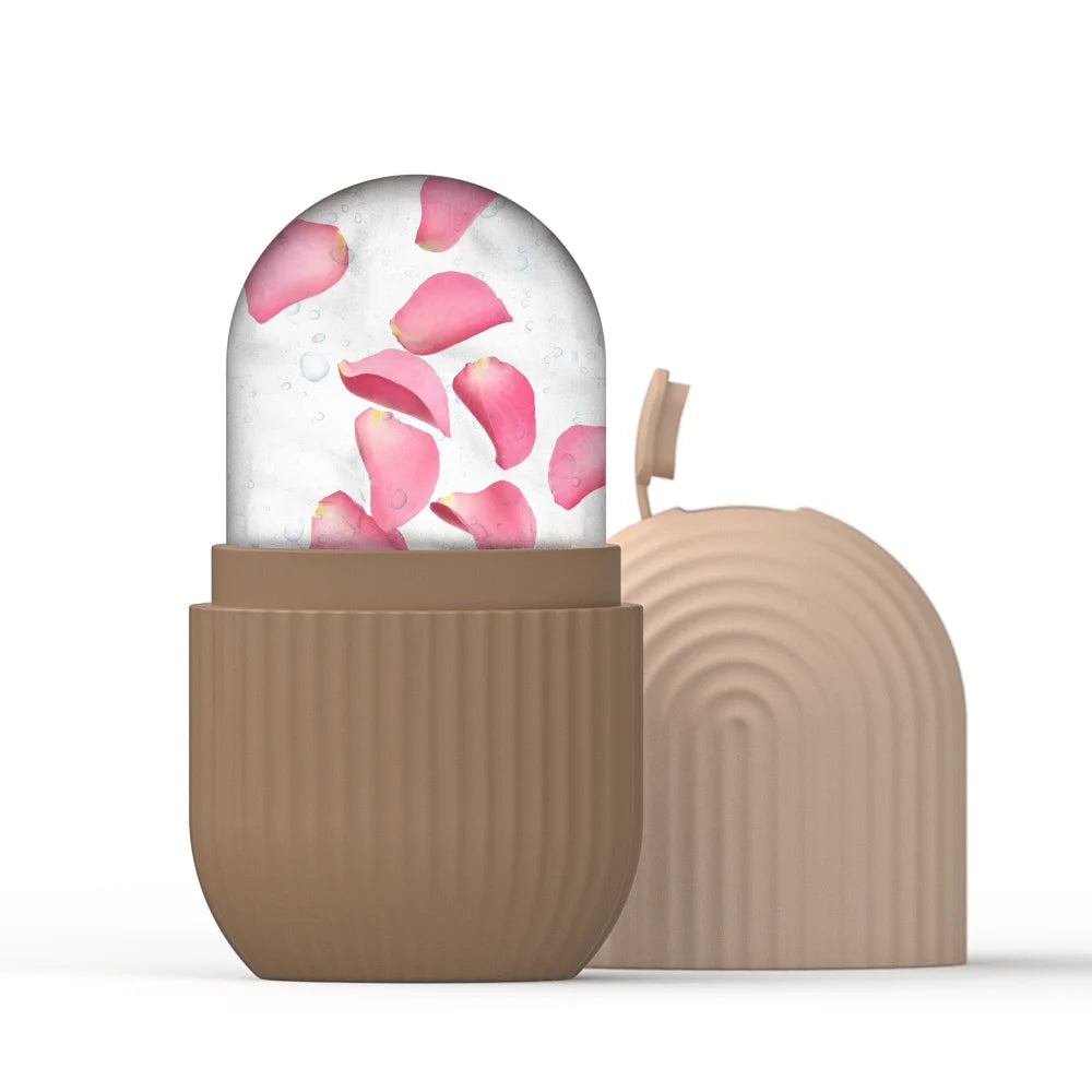 Reusable silicone ice face roller in tan, containing a clear ice sphere with pink rose petals inside.