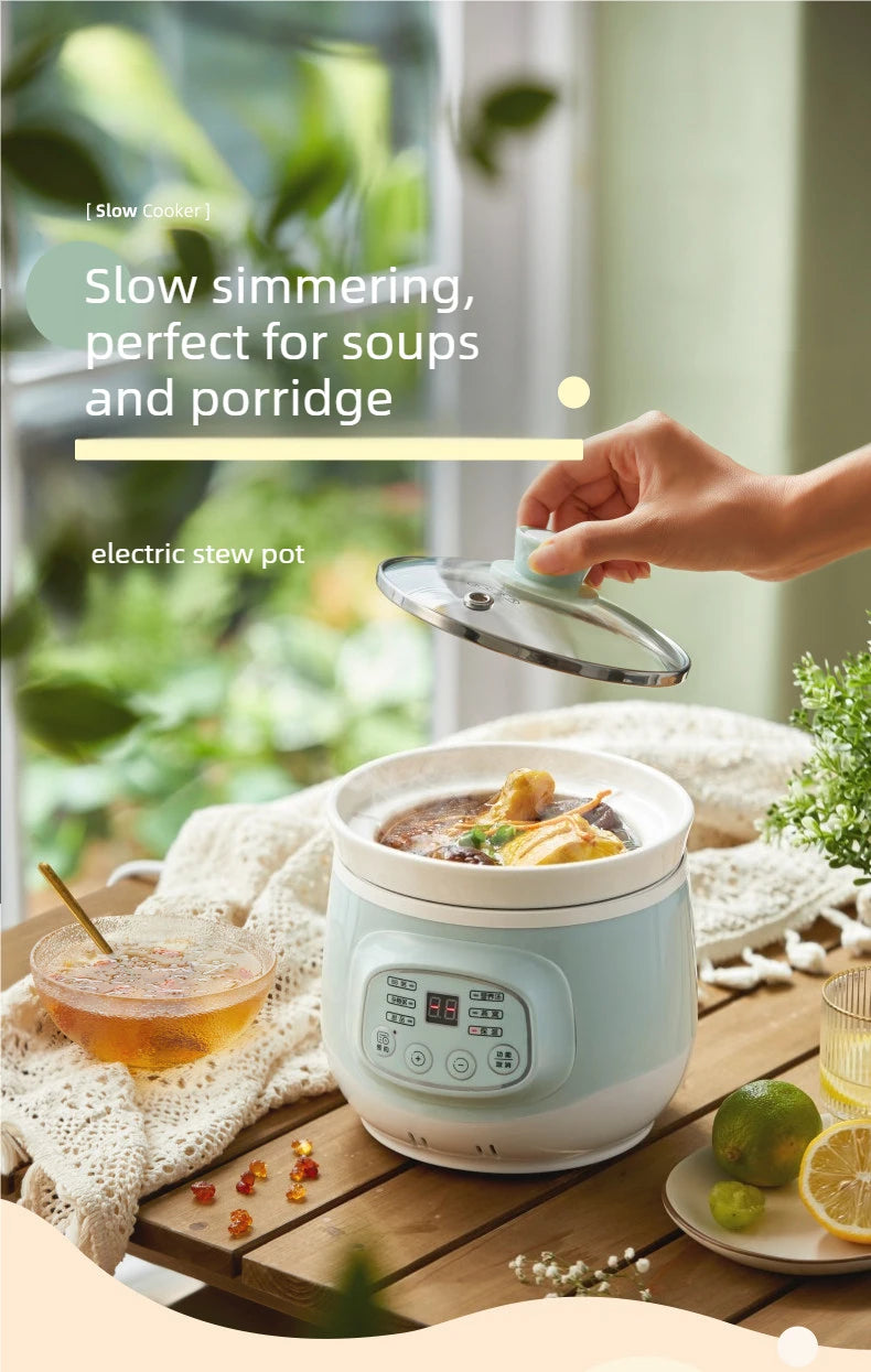 Electric stew pot with glass lid on a table, hand lifting the lid