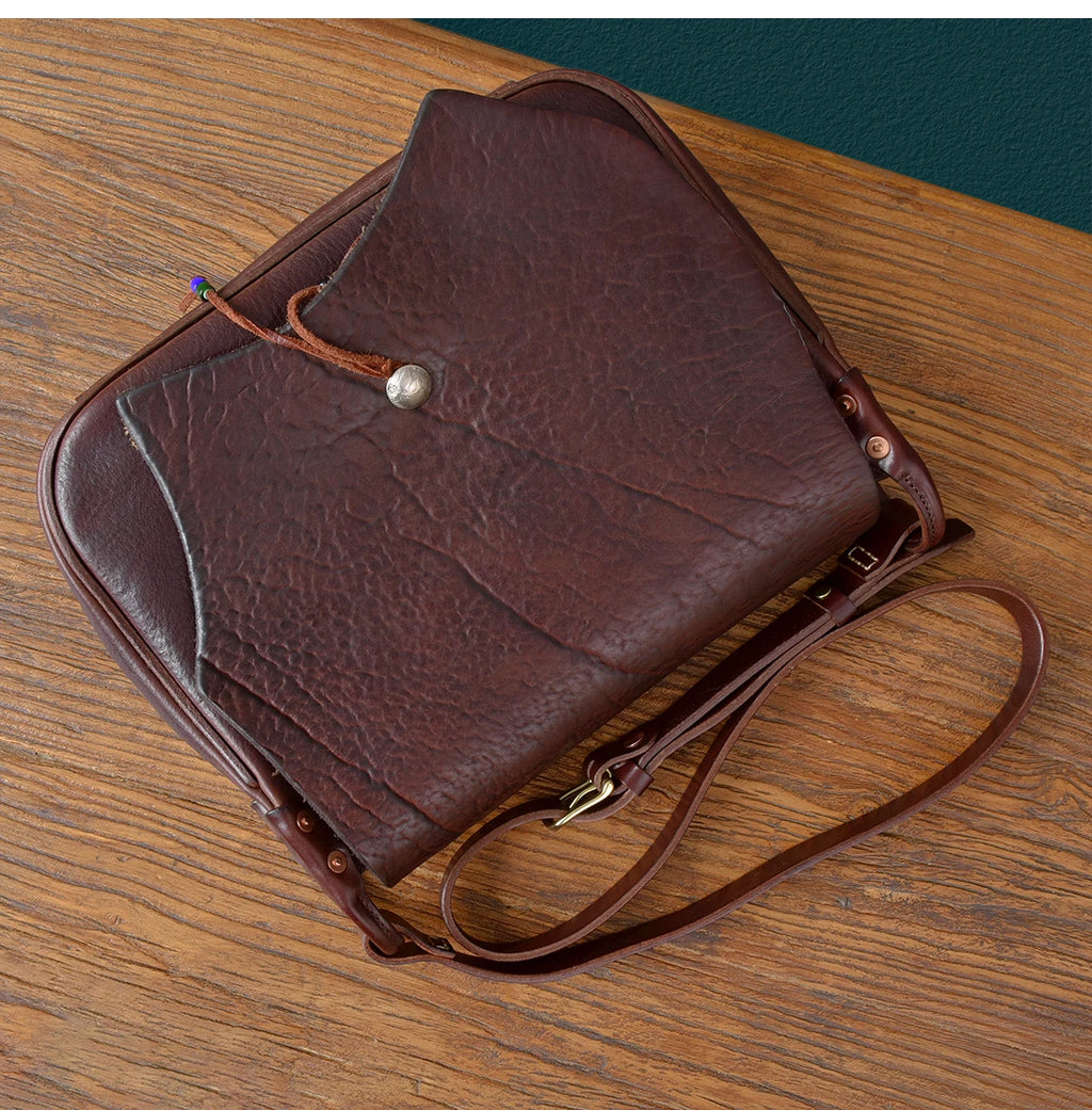 Vintage dark brown cowhide messenger bag, handmade genuine leather shoulder bag with a snap button and adjustable strap.