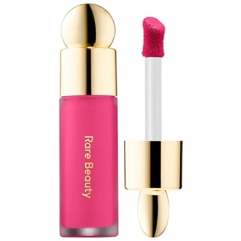 Rare Beauty matte liquid lipstick in vibrant pink with gold cap and doe-foot applicator for smooth, rich lip makeup.