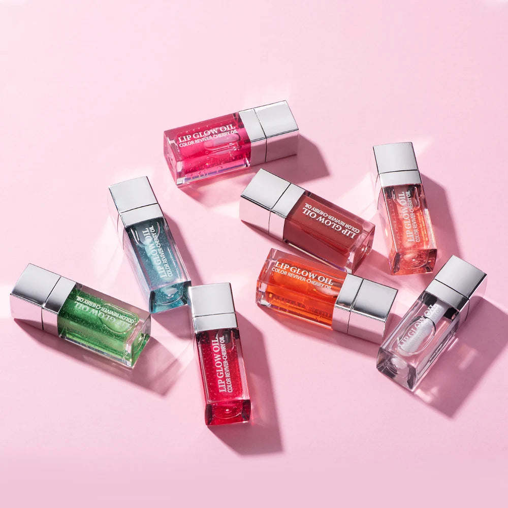 Set of 7 colorful crystal jelly lip glow oils in various tints for moisturizing, plumping, and glossy lip makeup.