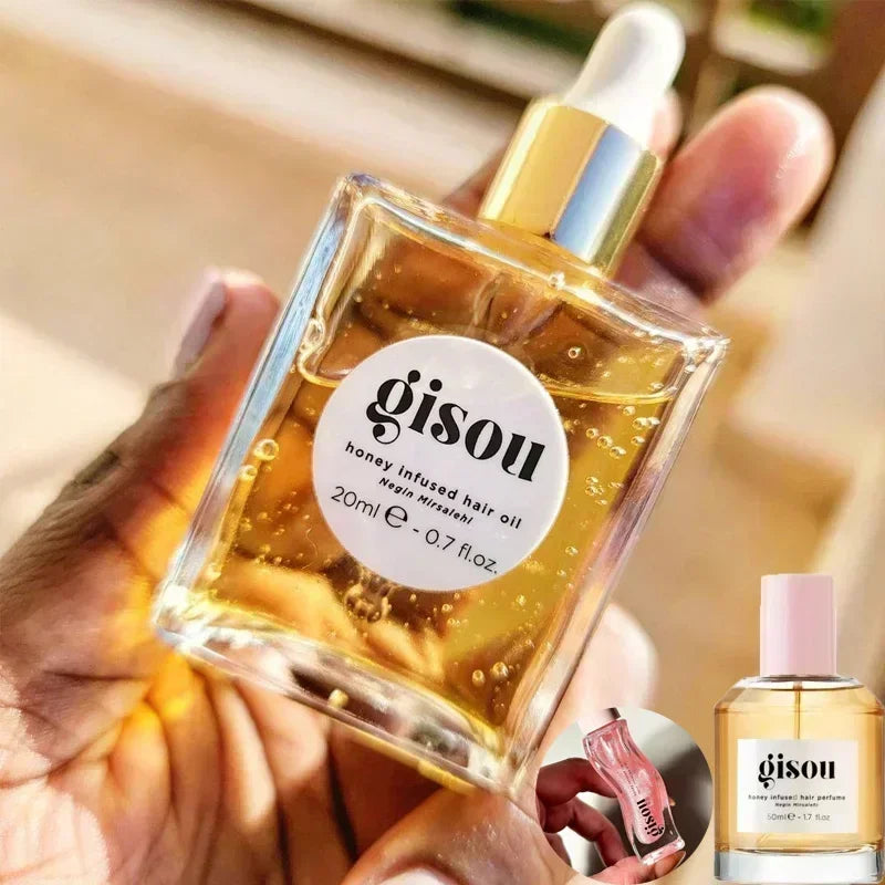Gisou honey-infused liquid lip oil in a glass dropper bottle, gold shimmering texture for moisturizing lip care.