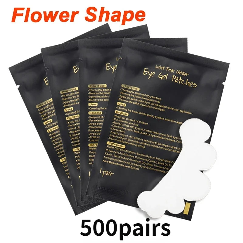 White flower-shaped lint-free gel eye patches for lash extensions in individual black packaging.