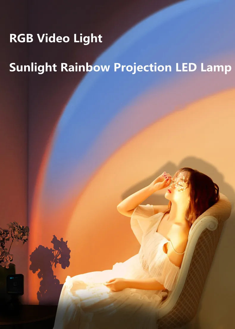 RGB LED projector lamp casting a colorful sunset and rainbow arc onto a wall to illuminate a woman in a chair.