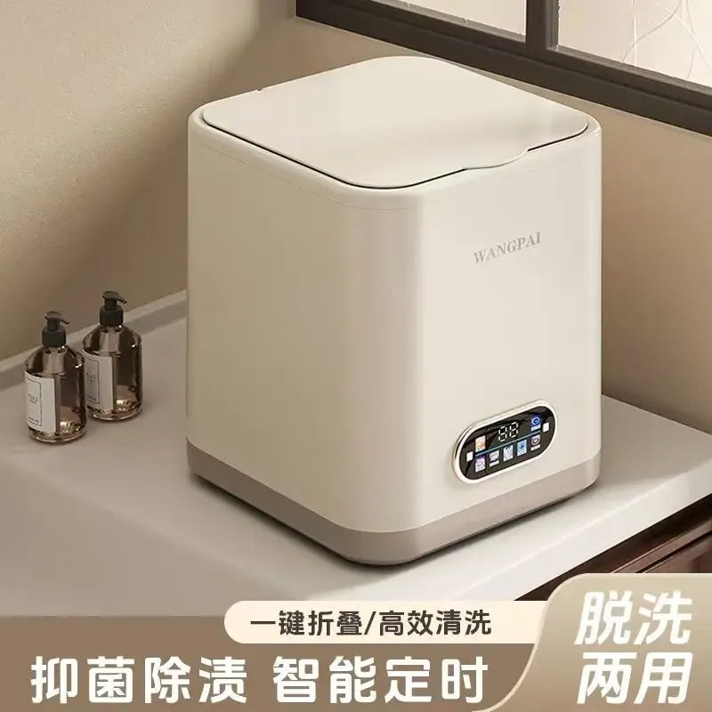 Portable mini washing machine with a sleek white design, digital control panel, and folding lid on a countertop.