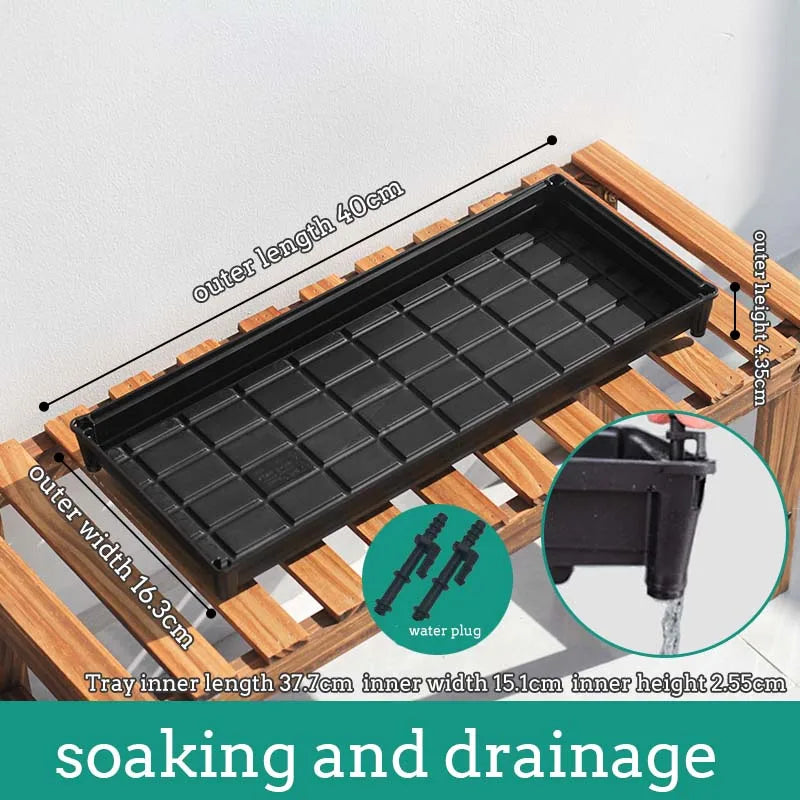 Black plastic window drainage tray with grid interior and water plug outlet for plant pots
