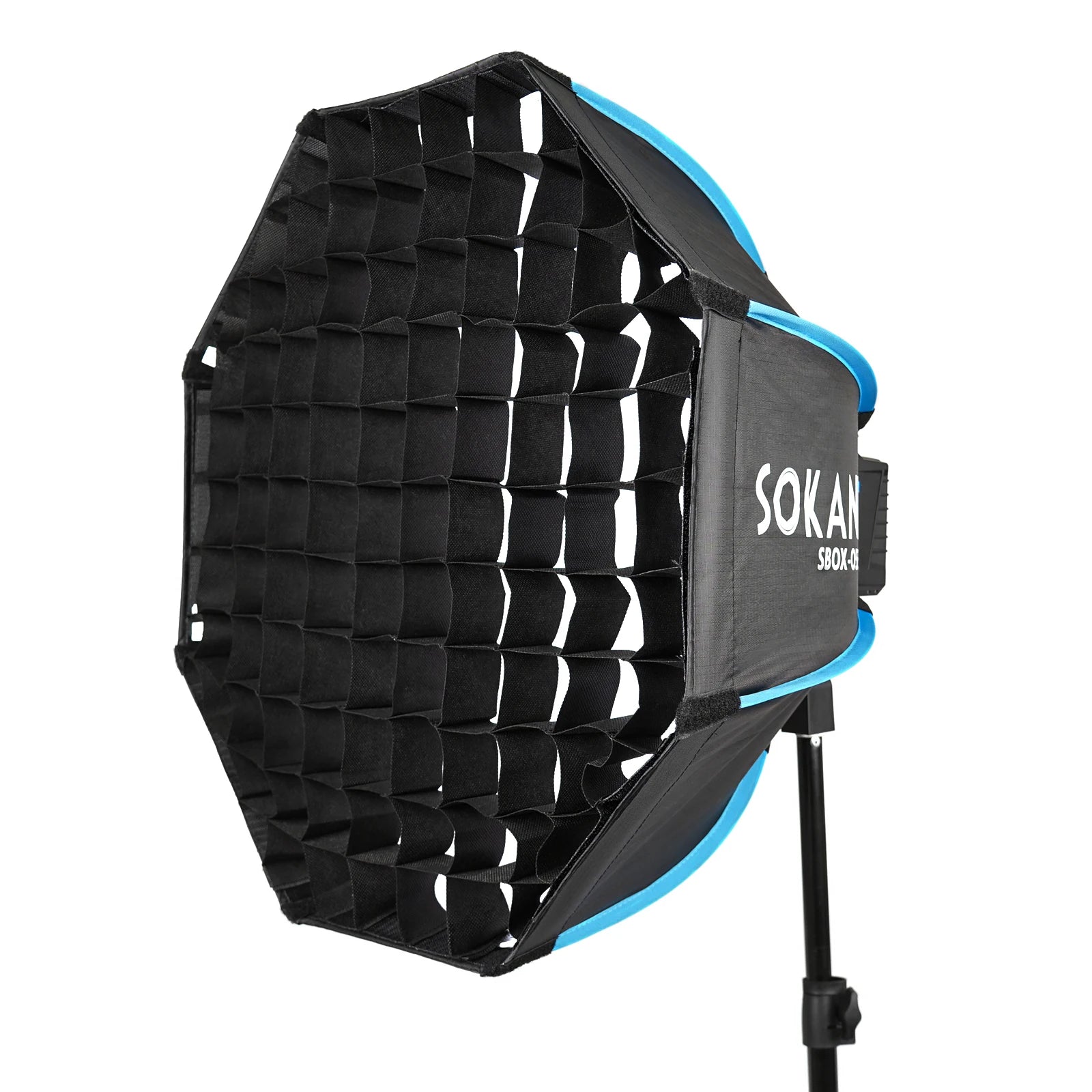 Octagonal softbox with a black fabric grid for lighting control, mounted on a stand for photography.