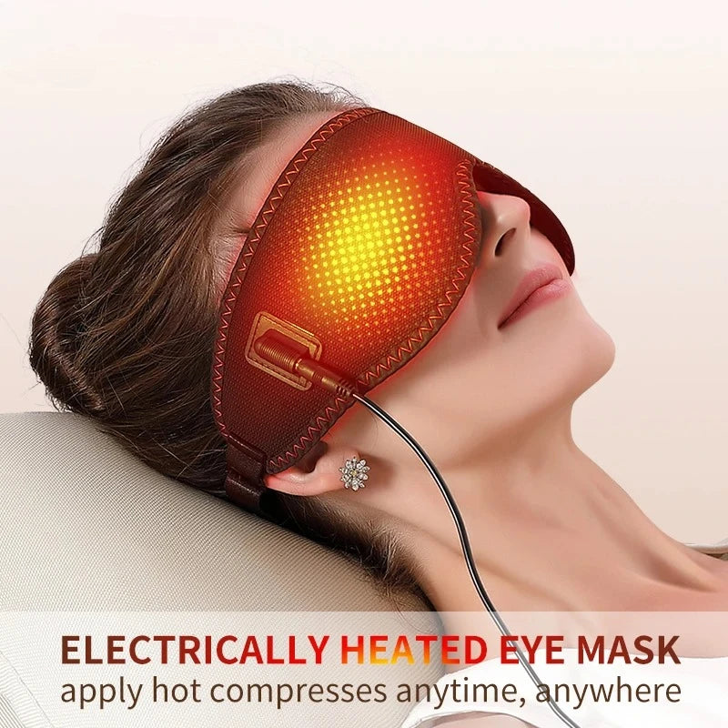 A woman reclines wearing a brown, electrically heated eye mask with a glowing, orange-patterned light over the eyes.