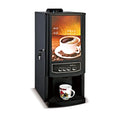 Black commercial coffee and tea vending machine with four-button interface and display graphic, white mug included.