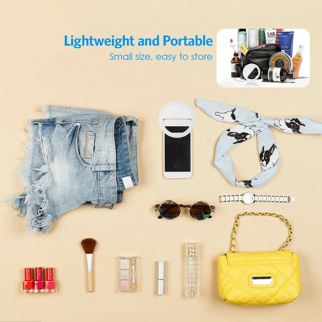 Round white portable selfie ring light with a clip for attaching to a smartphone, shown with various accessories.