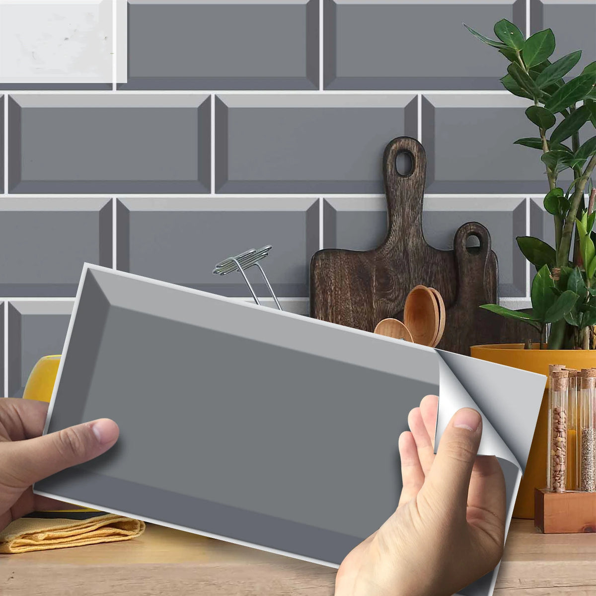 Peel-and-stick brick tile wall stickers, gray sheet being applied with peel backing