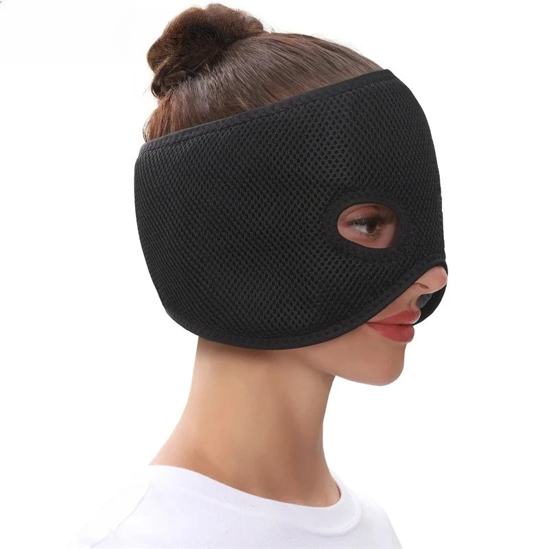 A woman wearing a black, mesh-textured, air-layer fabric heating half-face mask covering her eyes and cheeks.
