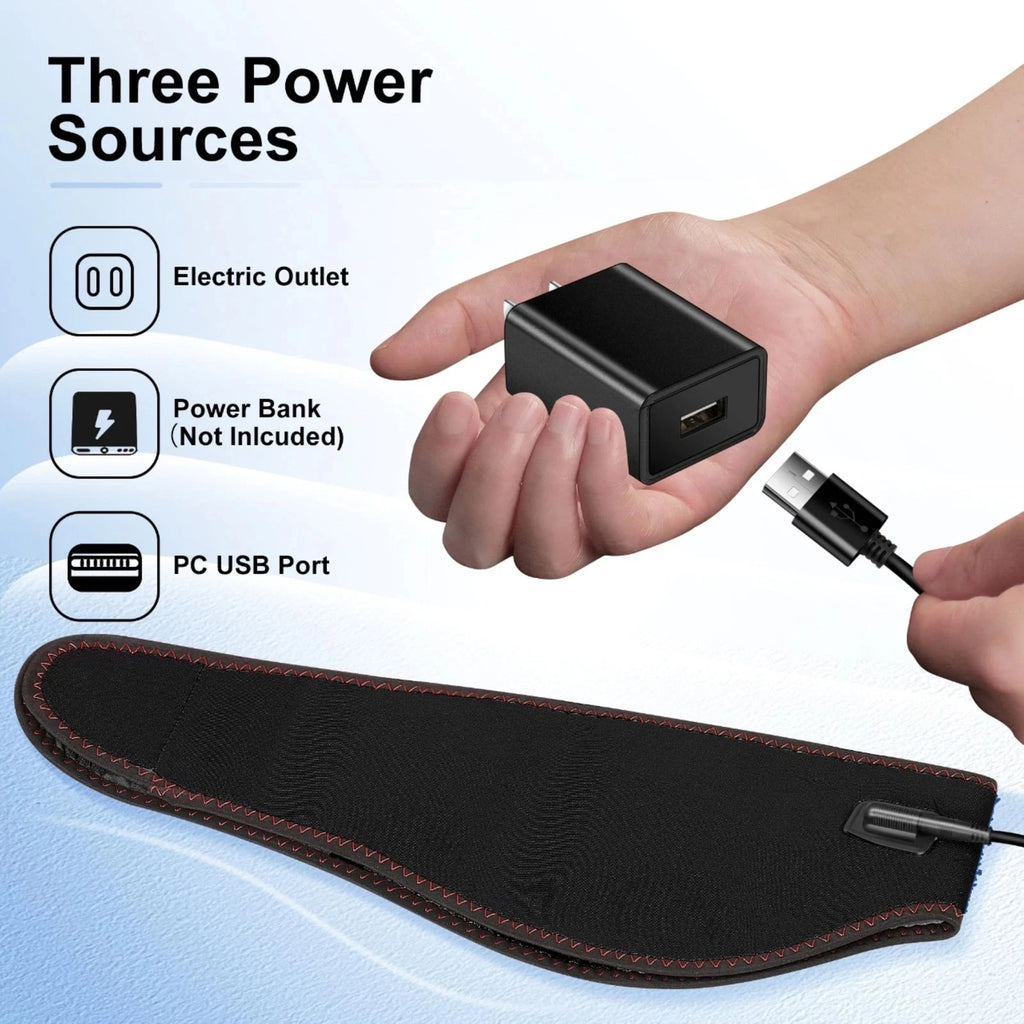 Black jaw heating pad with red stitching, shown with a USB cable and wall adapter for three power options.