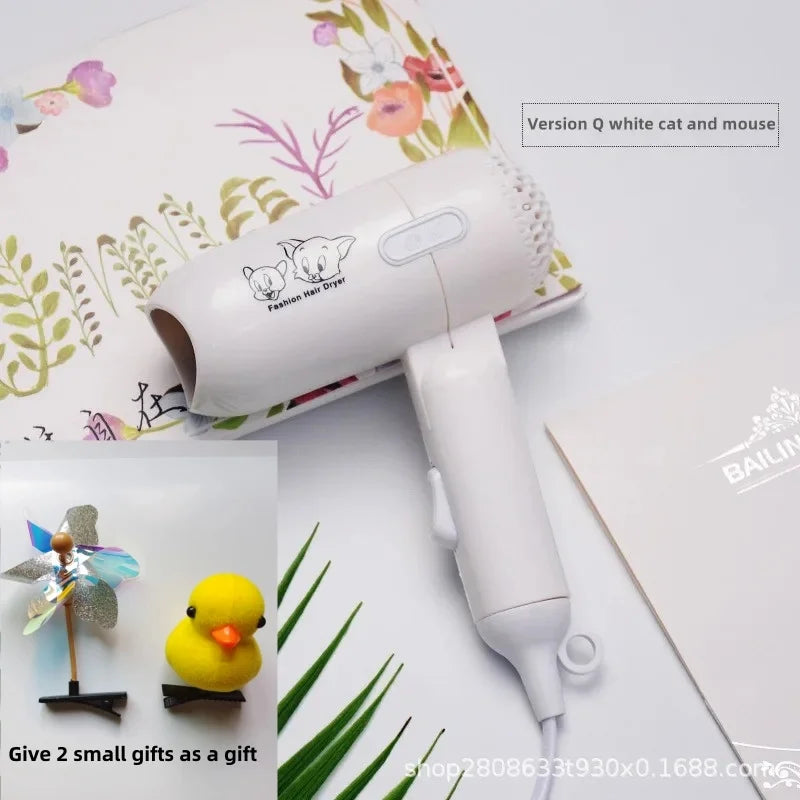 White mini folding hair dryer with cat/mouse print, 400W low-power travel tool, includes two cute hair accessories.