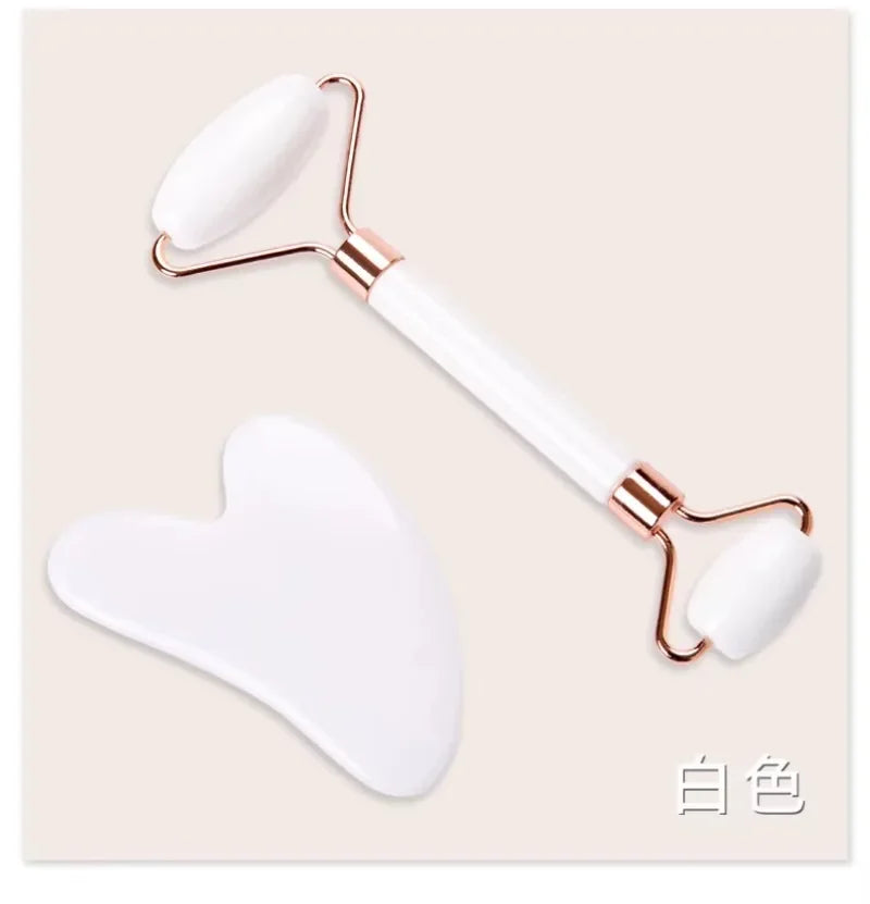 White resin facial roller and heart-shaped gua sha massage tool set for face lifting and anti-wrinkle skincare.
