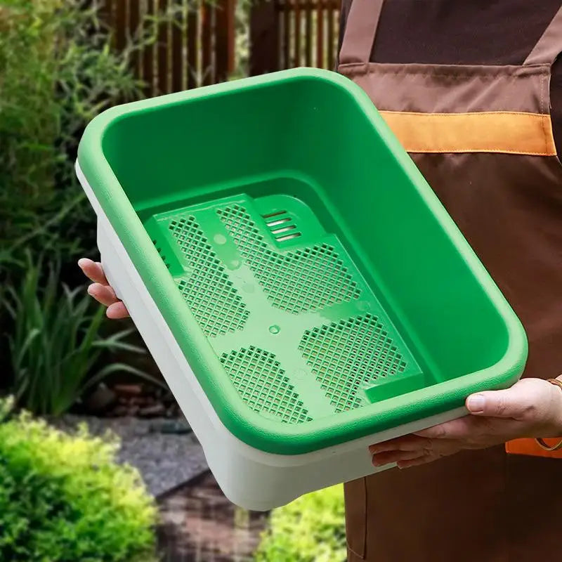 Green rectangular plastic planter tray with white sides and perforated insert