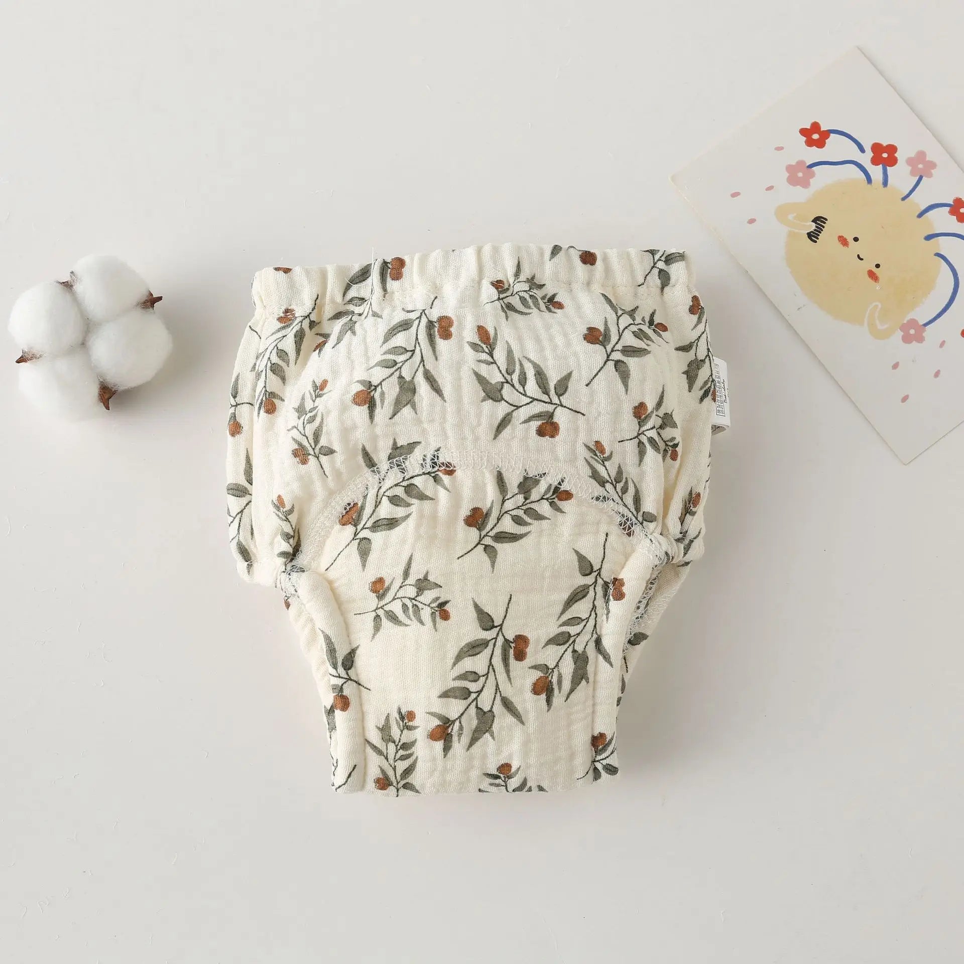 Floral cotton baby diaper cover with elastic waistband and botanical print for comfortable baby care.