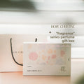 HOPE CHRISTINE floral-patterned perfume gift box with matching white paper shopping bag for mini fragrance collection.