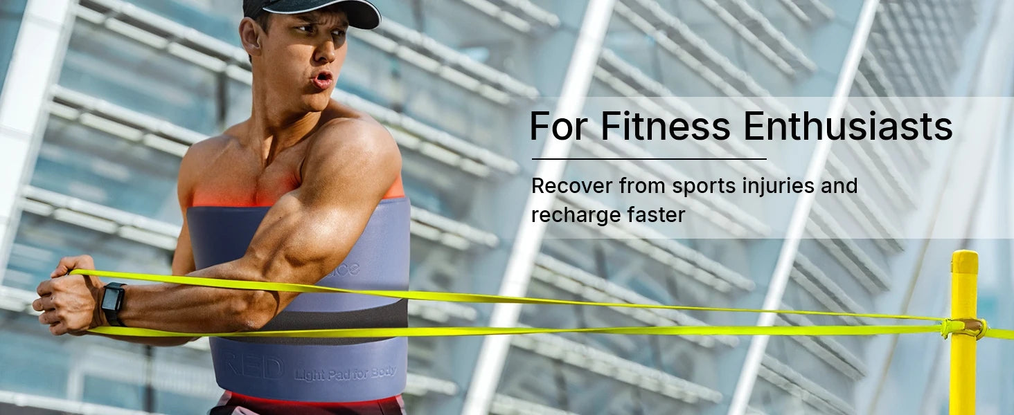 Athletic man wearing a blue flexible LED light therapy mat around his torso while using yellow resistance bands.