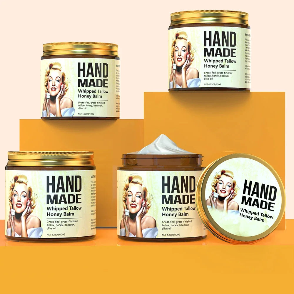 ENVISHA handmade whipped tallow honey balm face cream jars for moisturizing and nourishing skincare on yellow pedestals.