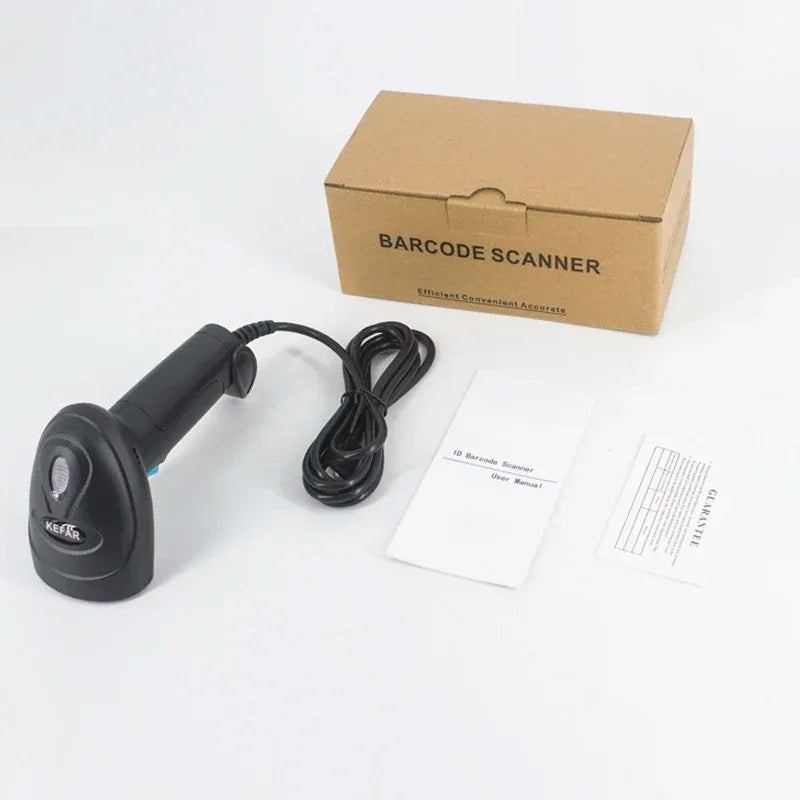 Black handheld barcode scanner with cable and papers, in front of a cardboard box