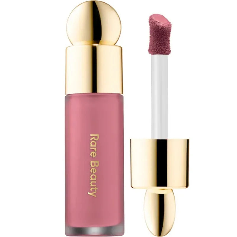 Rare Beauty matte liquid lipstick in a rich pink shade with gold cap and smooth applicator. Long-lasting lip makeup.