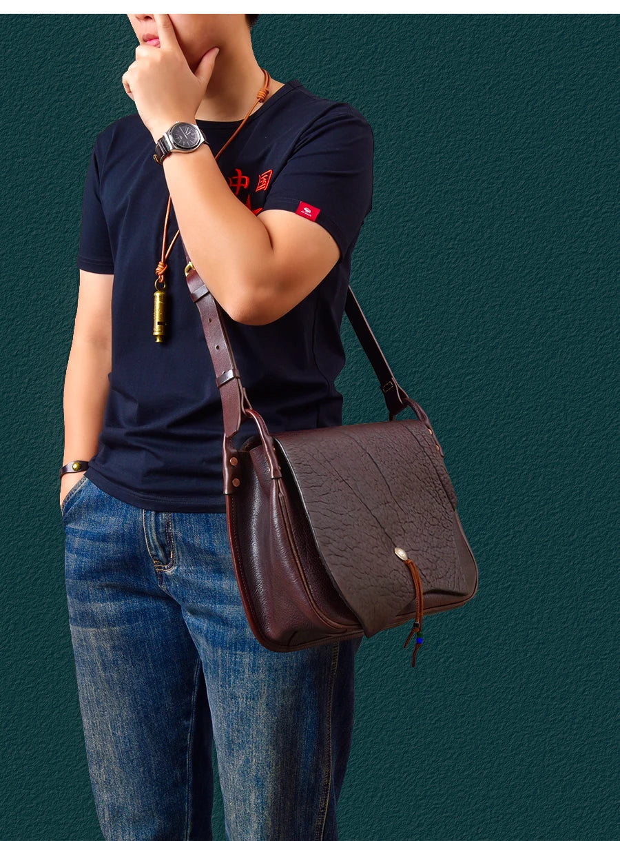 PNDME vintage dark brown cowhide leather messenger bag, handmade designer shoulder bag with flap and metal stud closure.