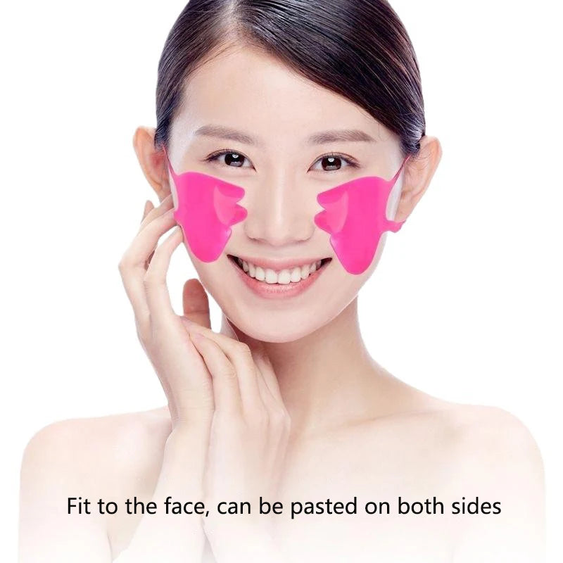 A woman wearing two bright pink, shaped silicone anti-wrinkle patches on her nasolabial fold areas.