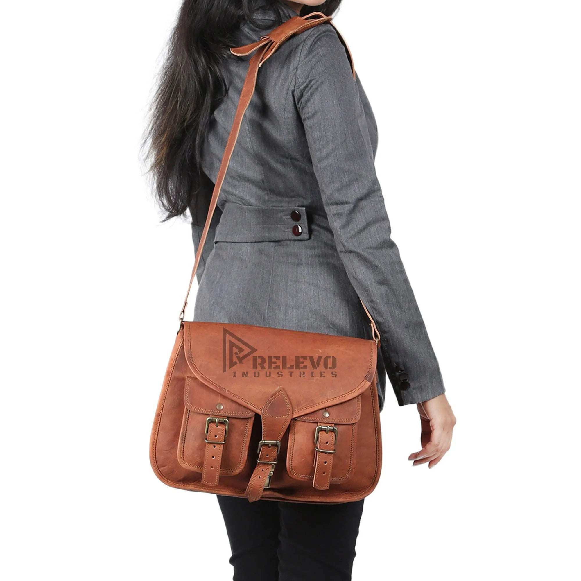 Women's tan leather designer shoulder bag with large capacity, dual front pockets, and adjustable buckle straps.