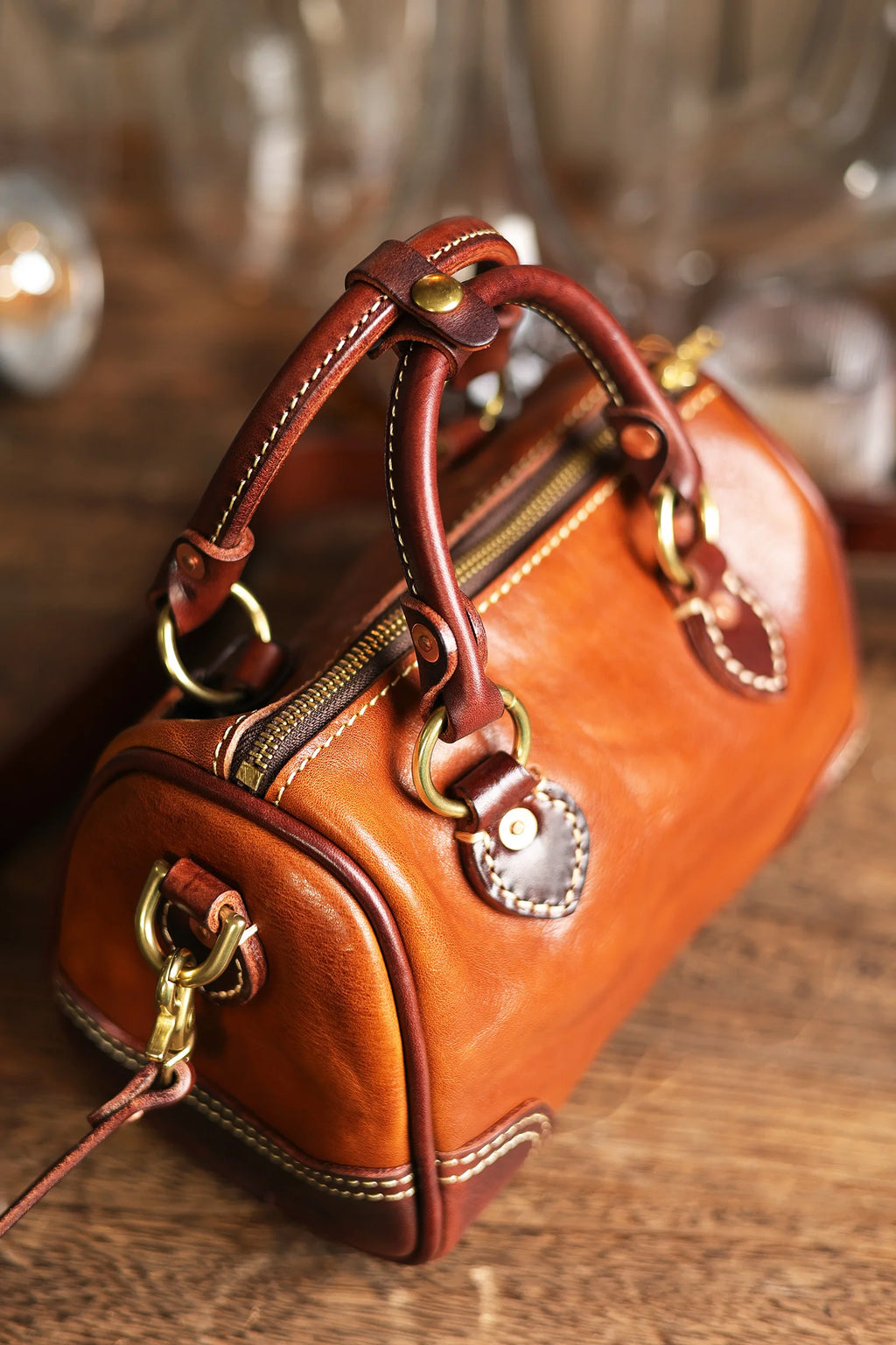 Vintage-style PNDME small brown genuine cowhide leather handbag with brass hardware and handmade stitched details.