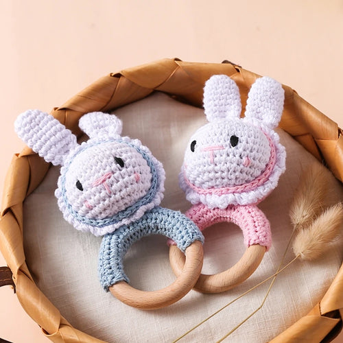 Blue and pink bunny natural wood teething rings for baby relief.
