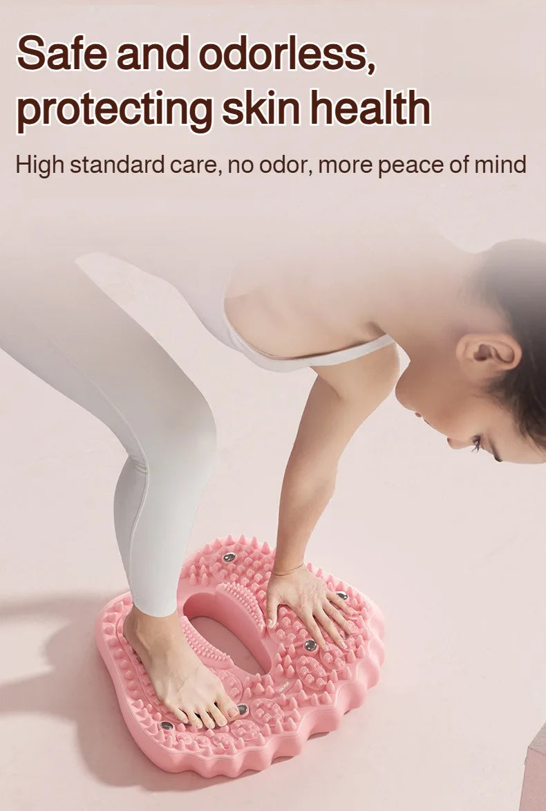 A woman balances on a pink, shaped acupoint massage mat featuring raised textures and embedded magnetic stones.