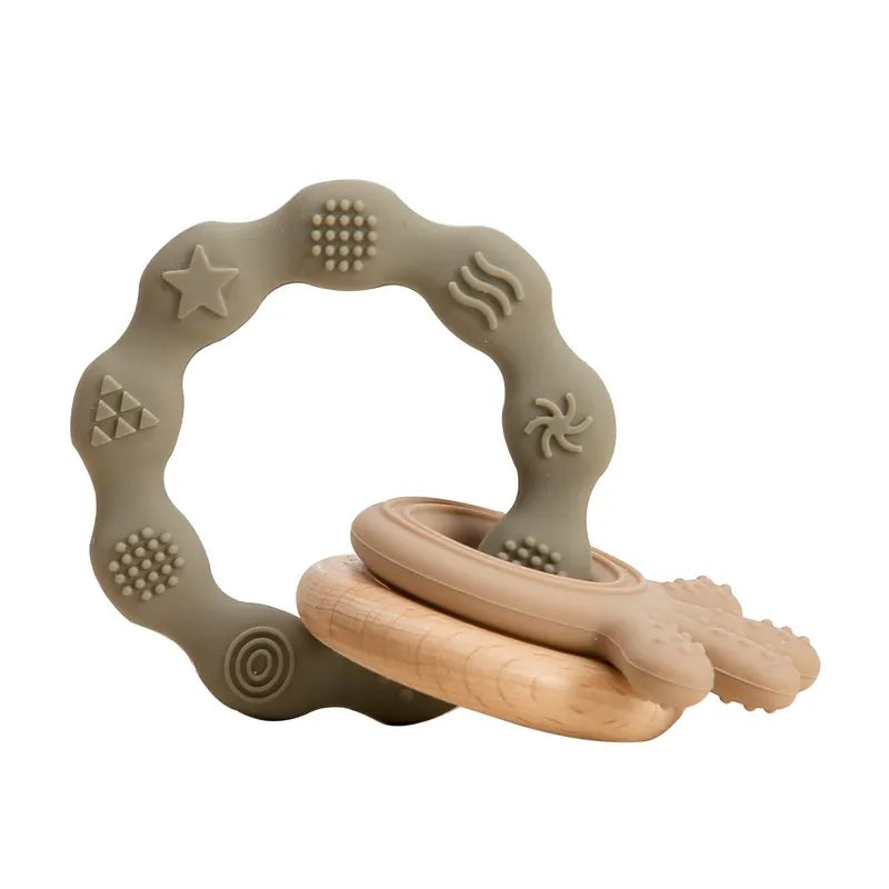 Sage green silicone and natural wood baby teething ring toy for infant pain relief.