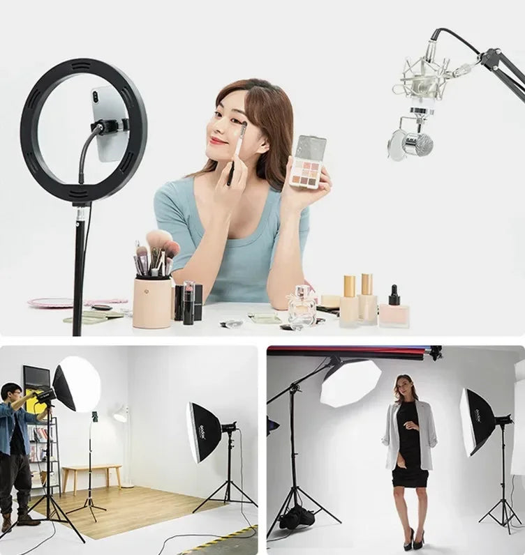 Black ring light with phone mount, studio microphones, and softbox lighting equipment for content creation.