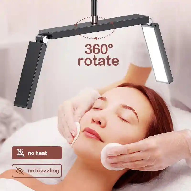 Black adjustable LED salon lamp with 360-degree rotating arms, used to illuminate a client during a facial treatment.