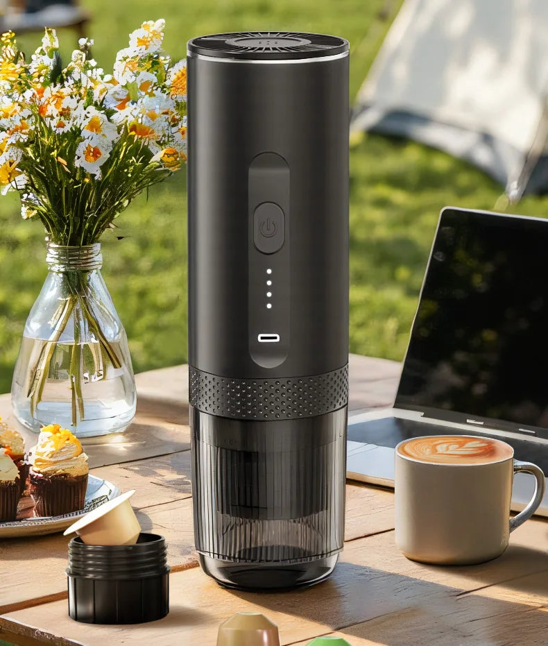 Matte black portable electric espresso maker with USB-C charging and clear reservoir for on-the-go coffee brewing.