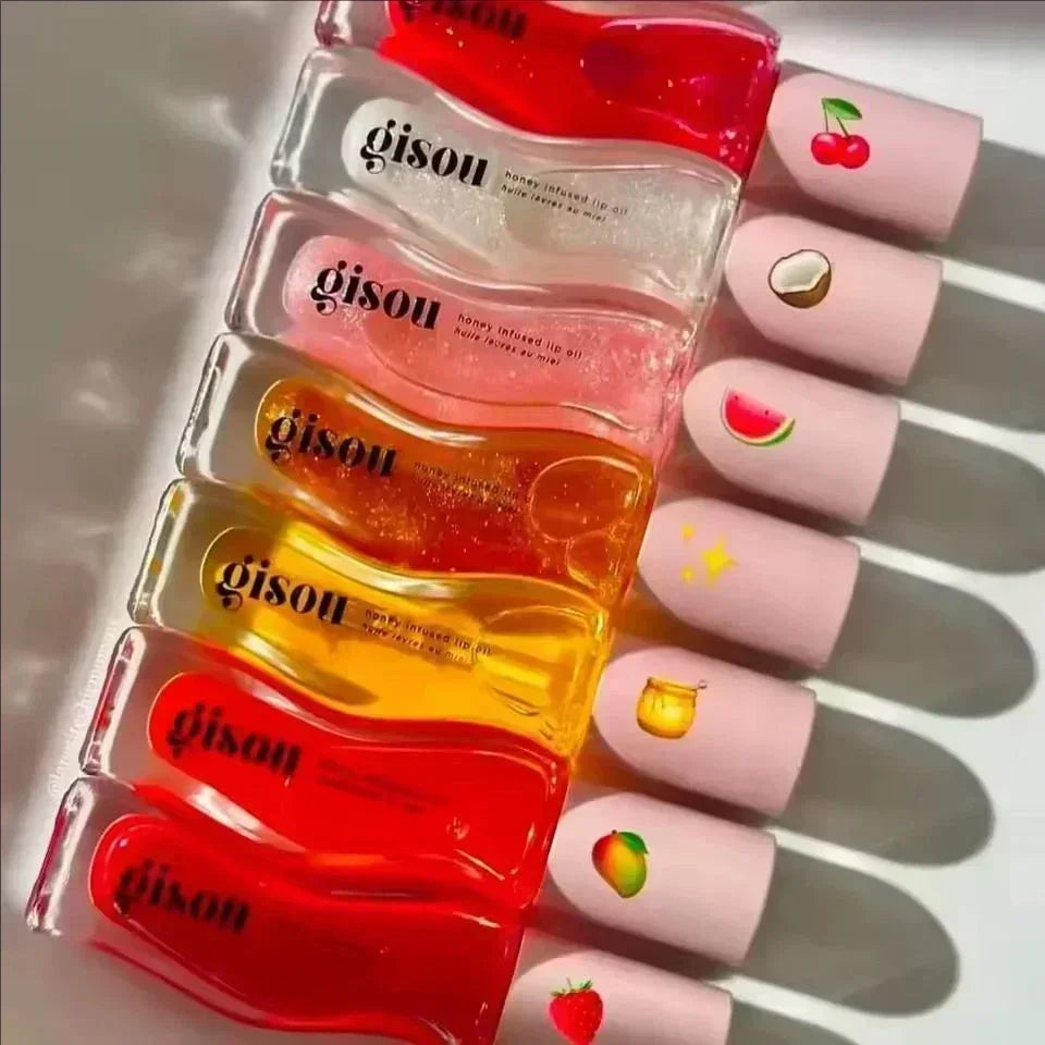 Gisou honey-infused moisturizing lip oils in colorful fruity scents with clear, glossy textures and cute cap icons.