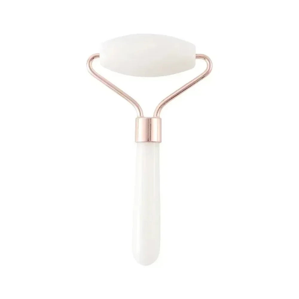 White resin facial roller massager with rose gold frame for anti-wrinkle skin care and face lift beauty routine.