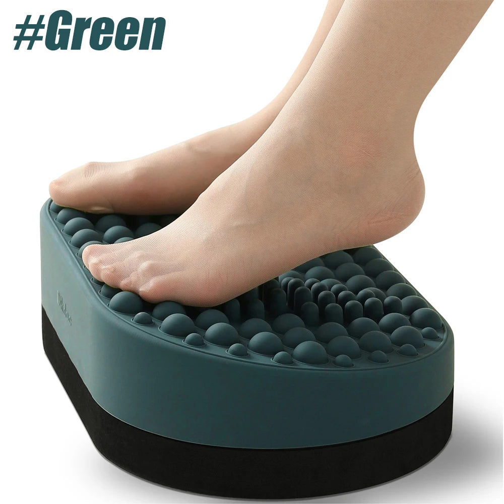 Green silicone under-desk foot rest with acupressure nodes for plantar fasciitis relief and ergonomic office comfort.