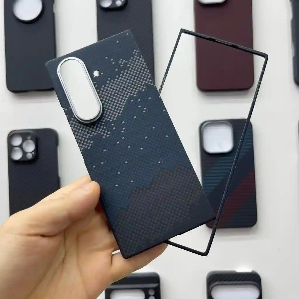 Textured navy blue aramid fiber smartphone case with a mountain pattern and raised camera border.