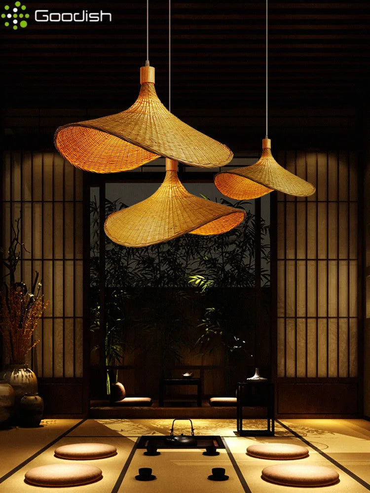 Three hanging cone-shaped bamboo pendant lights with a natural tan weave, suspended in a room for overhead lighting.