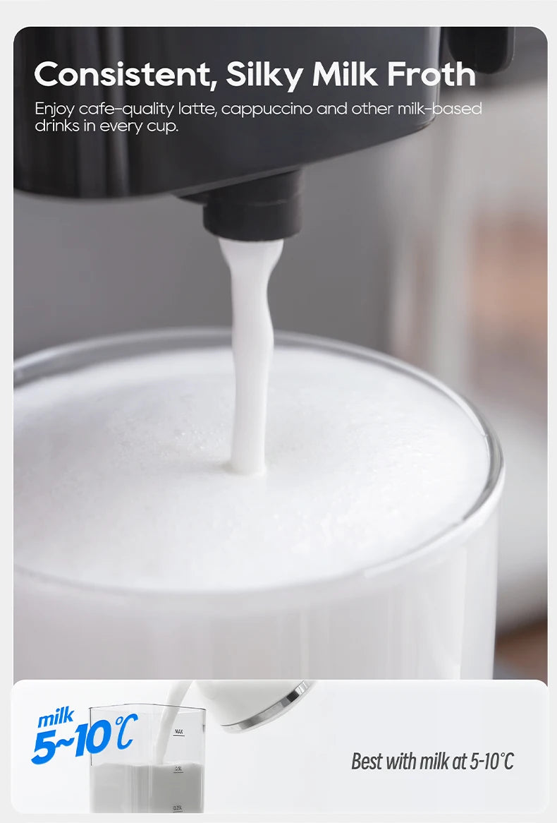 Black espresso machine milk frother dispensing silky white foam into a clear glass, showing optimal 5-10°C milk temp.